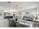 Inviting living room boasts an open floor plan, contemporary decor, and seamless flow into the adjacent kitchen at 7332 Mako Dr, Hudson, FL 34667