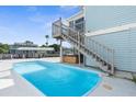 Private rectangular pool with wooden deck and hot tub at 7637 Hatteras Dr, Hudson, FL 34667