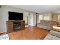 Living room with hardwood floors, sofas, and a fireplace at 12119 Sunny Glen Ln # H1, Hudson, FL 34669