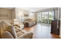 Living room featuring hardwood floors, comfy seating, and a view to a patio at 12119 Sunny Glen Ln # H1, Hudson, FL 34669