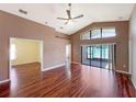 Bright living room with hardwood floors, vaulted ceiling and sliding doors to patio at 13626 Bryndlewood Ct, Hudson, FL 34669