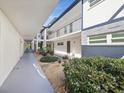 Building exterior with courtyard and landscaping at 1127 King Arthur Ct # 305, Dunedin, FL 34698