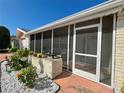 Inviting screened porch with seating area and lush landscaping at 10915 Bridleton Rd, Port Richey, FL 34668