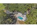 Aerial view showing home, pool, and surrounding trees at 18101 Mason Smith Rd, Brooksville, FL 34604