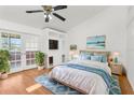 Bright primary bedroom with hardwood floors, access to a balcony, and a serene view at 10221 Elgin Blvd, Spring Hill, FL 34608