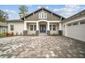 Inviting home entrance with a stylish blue double-door and stone pillar accents at 19395 Sheltered Hill Dr, Brooksville, FL 34601