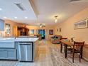 Spacious living room with an open floor plan, stylish decor, and seamless flow to the dining area at 2154 Tarpon Landings Dr, Tarpon Springs, FL 34688
