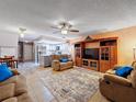 Cozy living room with plush seating, large TV, and adjacent kitchen area at 2154 Tarpon Landings Dr, Tarpon Springs, FL 34688