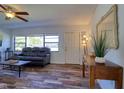 Living room with dark leather sofa and wood console table at 5800 & 5802 Tennessee Ave, New Port Richey, FL 34652