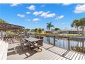 Deck overlooking a canal with table and chairs at 41 Cypress Dr, Palm Harbor, FL 34684