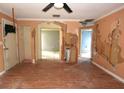 Extensive damage to walls and flooring in this living room at 3117 Laird Dr, New Port Richey, FL 34655