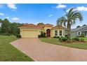 Single-Gathering home with brick driveway and palm tree at 9312 Gentle Ben Ct, Weeki Wachee, FL 34613