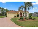 Single-Gathering home with brick driveway and palm tree at 9312 Gentle Ben Ct, Weeki Wachee, FL 34613