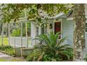 Light blue house with white porch at 14335 Snow Memorial Hwy, Brooksville, FL 34601