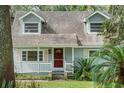 Light blue house with white porch at 14335 Snow Memorial Hwy, Brooksville, FL 34601