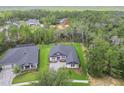 A high angle view showcases the property nestled amidst mature trees in a serene, suburban setting at 6109 Dusk Rose Ln, Brooksville, FL 34601