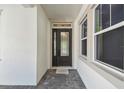 Elegant front entry featuring a decorative glass door, sidelights, and gray-tone paver flooring at 6109 Dusk Rose Ln, Brooksville, FL 34601