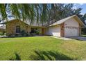 House exterior featuring stone accents and a well-manicured lawn at 9142 Brooker Dr, New Port Richey, FL 34655