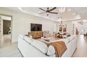 Open concept living room with sectional sofa and large TV at 11313 Limpkin Rd, Weeki Wachee, FL 34614