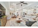 Open living room and kitchen with light hardwood floors and neutral decor at 11313 Limpkin Rd, Weeki Wachee, FL 34614
