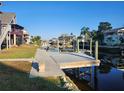 Private wooden dock extending into the waterway; perfect for relaxing and enjoying the water views at 6428 Driftwood Dr, Hudson, FL 34667