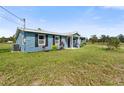 Newly constructed blue home with a grassy yard at 13187 Montour St, Brooksville, FL 34613