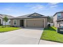 Single-story home with attached garage and landscaped lawn at 12894 Impatiens St, Spring Hill, FL 34609