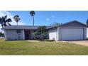 Single-story home with manicured lawn and an attached two-car garage at 3544 Wilson Dr, Holiday, FL 34691