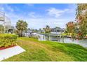 Green backyard with water views, tropical foliage and plenty of room to relax at 6310 Garland Ct, New Port Richey, FL 34652