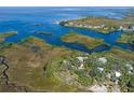 Stunning aerial view of waterfront property with lush landscape at 8812 Camp Ln, Hudson, FL 34667