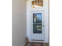 Inviting front entrance with a decorative glass door and welcome mat at 13215 Golf Ridge Pl, Hudson, FL 34669