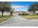 House exterior with driveway and landscaping at 647 Wilsford Ln, Spring Hill, FL 34609