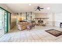 Spacious living room featuring a brick fireplace, tile floors and comfortable seating at 10824 Peppertree Ln, Port Richey, FL 34668