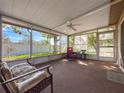 Enclosed patio with ceiling fan and plenty of light provides a relaxing space at 10824 Peppertree Ln, Port Richey, FL 34668