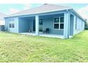 A well-maintained lawn surrounds a covered patio in this home's backyard at 13447 Newport Shores Dr, Hudson, FL 34669