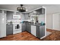 Modern gray kitchen with granite countertops and wood floors at 3423 Umber Rd, Holiday, FL 34691