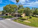 Single-story home with a well-maintained lawn and driveway at 10824 Peppertree Ln, Port Richey, FL 34668