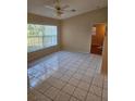 Spacious living room featuring tile flooring and large window at 8096 Darts St, Weeki Wachee, FL 34613