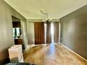 Neutral dining room featuring tile floors, modern light fixtures, and view to the kitchen area at 10521 Mira Vista Dr, Port Richey, FL 34668