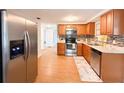 The kitchen showcases stainless steel appliances, sleek cabinets, and leads seamlessly into the adjacent dining area at 4041 Las Vegas Dr, New Port Richey, FL 34653