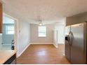 Simple dining area with hardwood floors and a view to the kitchen at 4041 Las Vegas Dr, New Port Richey, FL 34653