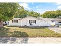 Newly renovated ranch-style home with white brick exterior and attached garage at 7240 Nova Scotia Dr, Port Richey, FL 34668