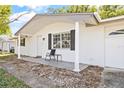 Front view of a charming ranch home with white brick exterior and covered porch at 7240 Nova Scotia Dr, Port Richey, FL 34668