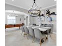 Elegant dining room with a large chandelier and seating for eight at 12135 Crestridge Loop, Trinity, FL 34655