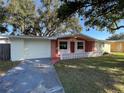 Front view of a ranch-style home with a brick facade at 5319 Whippoorwill Dr, Holiday, FL 34690
