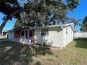 Side view of a ranch home with brick accents and landscaping at 5319 Whippoorwill Dr, Holiday, FL 34690