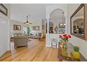 Bright living room with hardwood floors, comfy seating, and a view to the dining area at 13517 Hunters Point St, Spring Hill, FL 34609