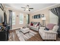 Inviting living room with hardwood floors, neutral walls, and comfortable seating at 10595 Marsha Dr, New Port Richey, FL 34655