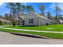 Beautiful single-story home featuring a well-maintained lawn and neutral color scheme at 19364 Sheltered Hill Dr, Brooksville, FL 34601