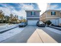 Two-car garage with gray exterior and a paved driveway at 10595 Marsha Dr, New Port Richey, FL 34655